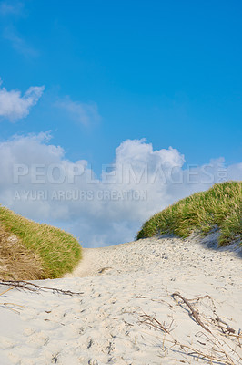 Buy stock photo Background, blue sky and beach dune in environment for peace, nature and tropical island for travel or vacation. Sand, clouds and bushes with shore, landscape and outdoor summer for holiday adventure