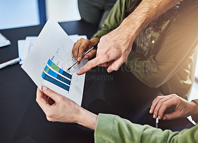 Buy stock photo Cropped shot of businesspeople looking through some paperwork in an office