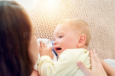 Buy stock photo Shot of a mother trying to put her baby to sleep