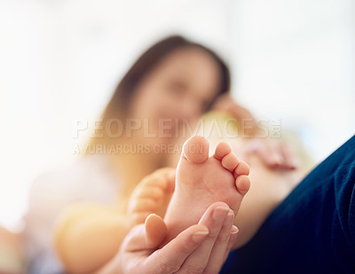 Buy stock photo Cropped shot of a mother touching her baby's foot