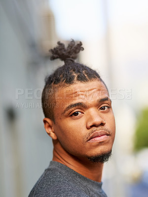 Buy stock photo Portrait, black man and cool or funky hairstyle in city with topknot and braided hair for barbershop. Creative, unconventional and serious african person, face or identity expression with urban style