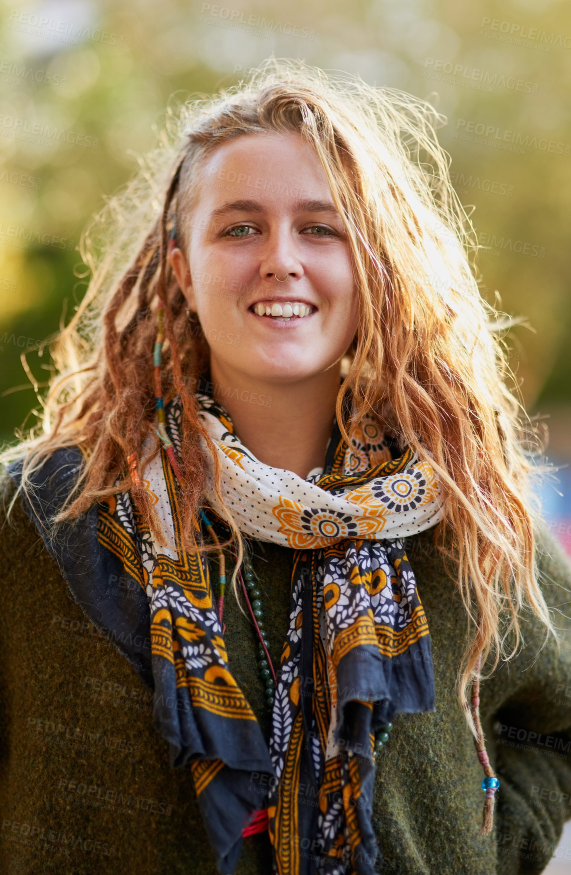 Buy stock photo Portrait of a young woman with dreadlocks posing outdoors