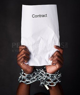 Buy stock photo Hands, chains and document for contract, legal and law with employment and modern slavery. Person, closeup or worker with paperwork, scam or agreement with corporate bondage on dark studio background