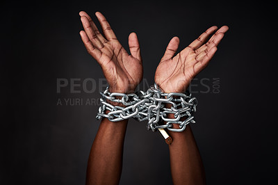 Buy stock photo Studio, person and hands with lock on chain for crime, arrest and justice on black background. Guilty man, criminal suspect and shackles on prisoner for money laundering, fraud and corruption