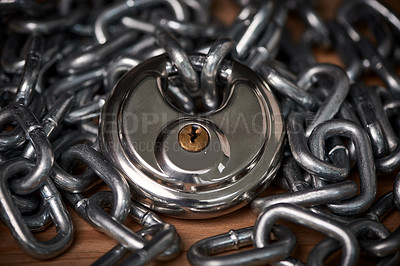 Buy stock photo Security, steel and chain with lock for safety on wooden surface for privacy or protection. Metal, equipment and iron padlock and link shackles on table for password or guard with key for secret.