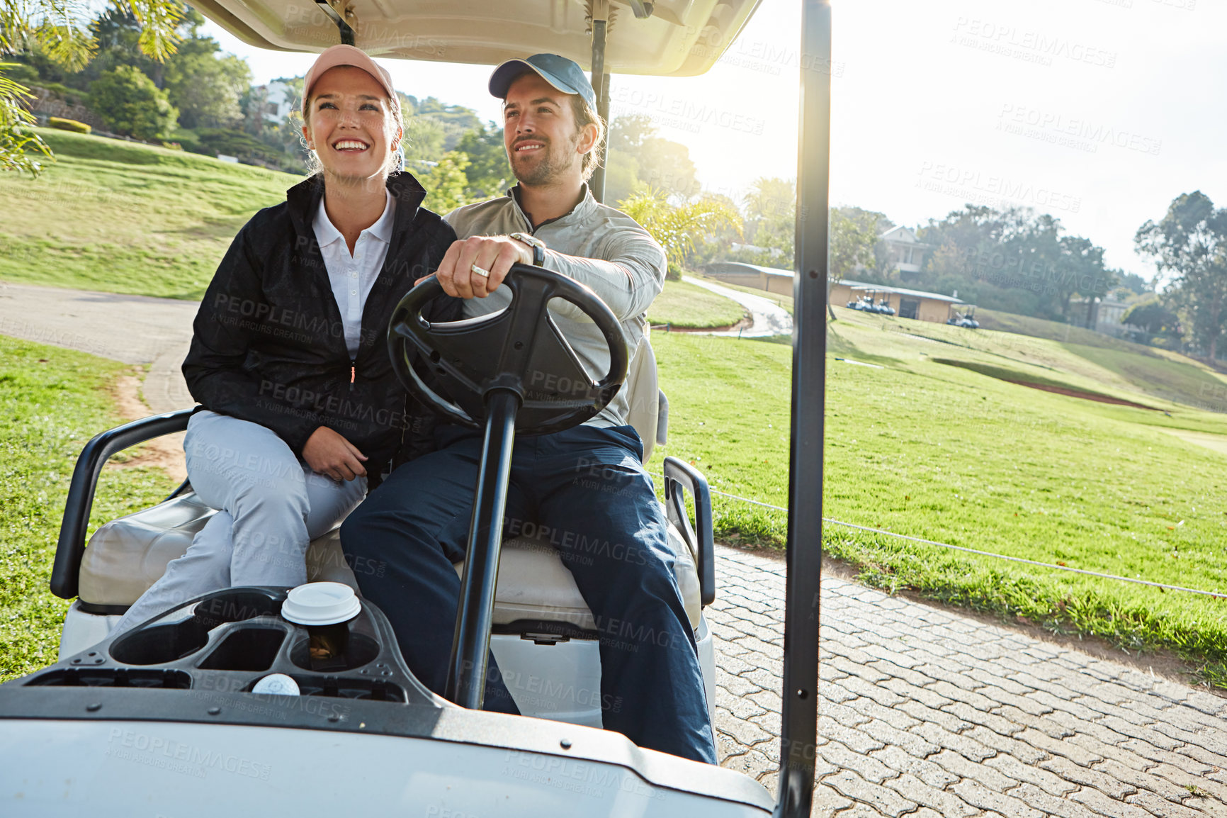 Buy stock photo Couple, driving and golf cart for sports, game and recreation with weekend hobby, bonding and fitness. People, love and happy on course for exercise, practice and fun club competition with leisure