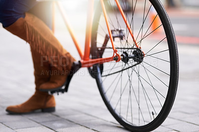 Buy stock photo Cropped shot of a woman standing alongside a bicycle