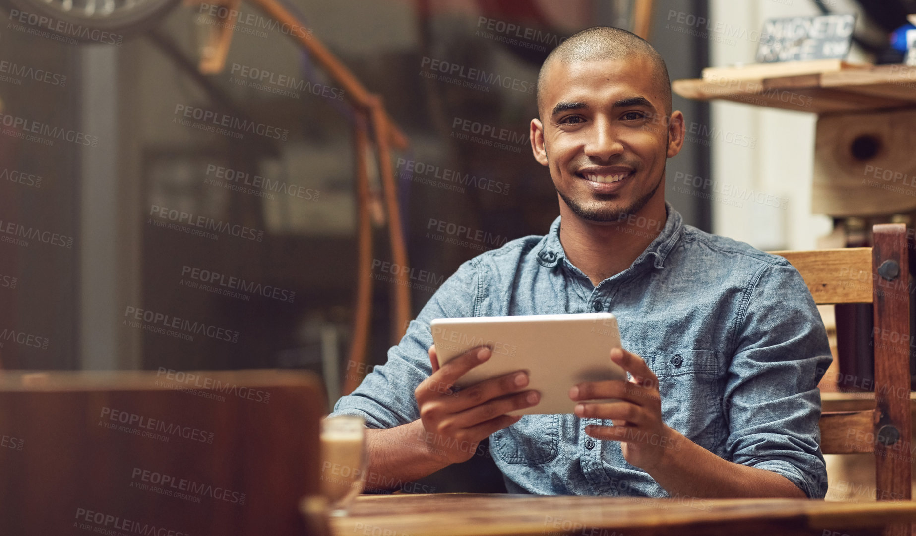 Buy stock photo Portrait of a young entrepreneur using a digital tablet in his store