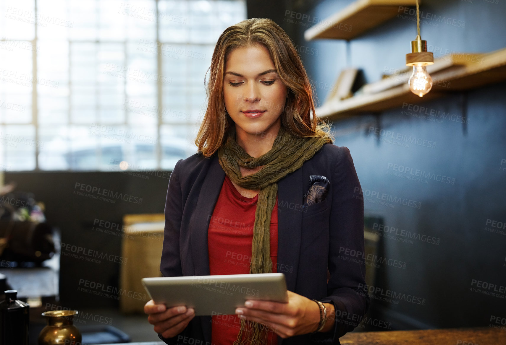 Buy stock photo Cropped shot of a young business owner using a digital tablet in her shop