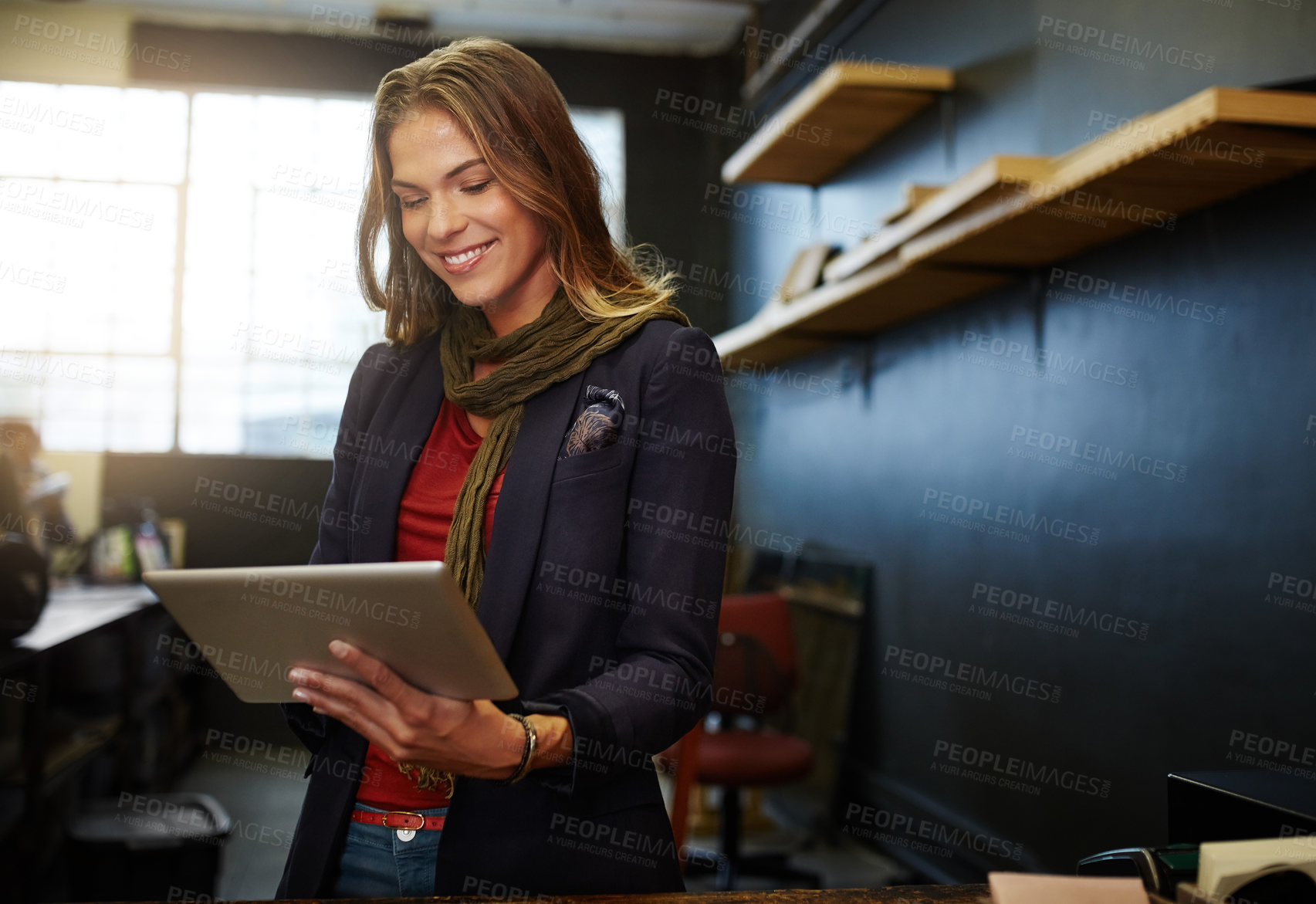 Buy stock photo Cropped shot of a young business owner using a digital tablet in her shop