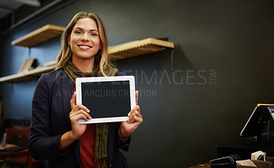 Buy stock photo Portrait of a young business owner using a digital tablet in her shop