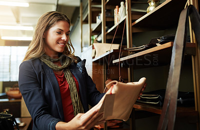 Buy stock photo Cropped shot of a young woman shopping in a leatherwork store