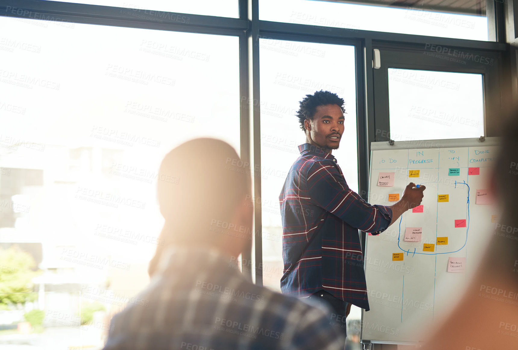 Buy stock photo Cropped shot of a businessman giving a presentation to his coworkers in a modern office