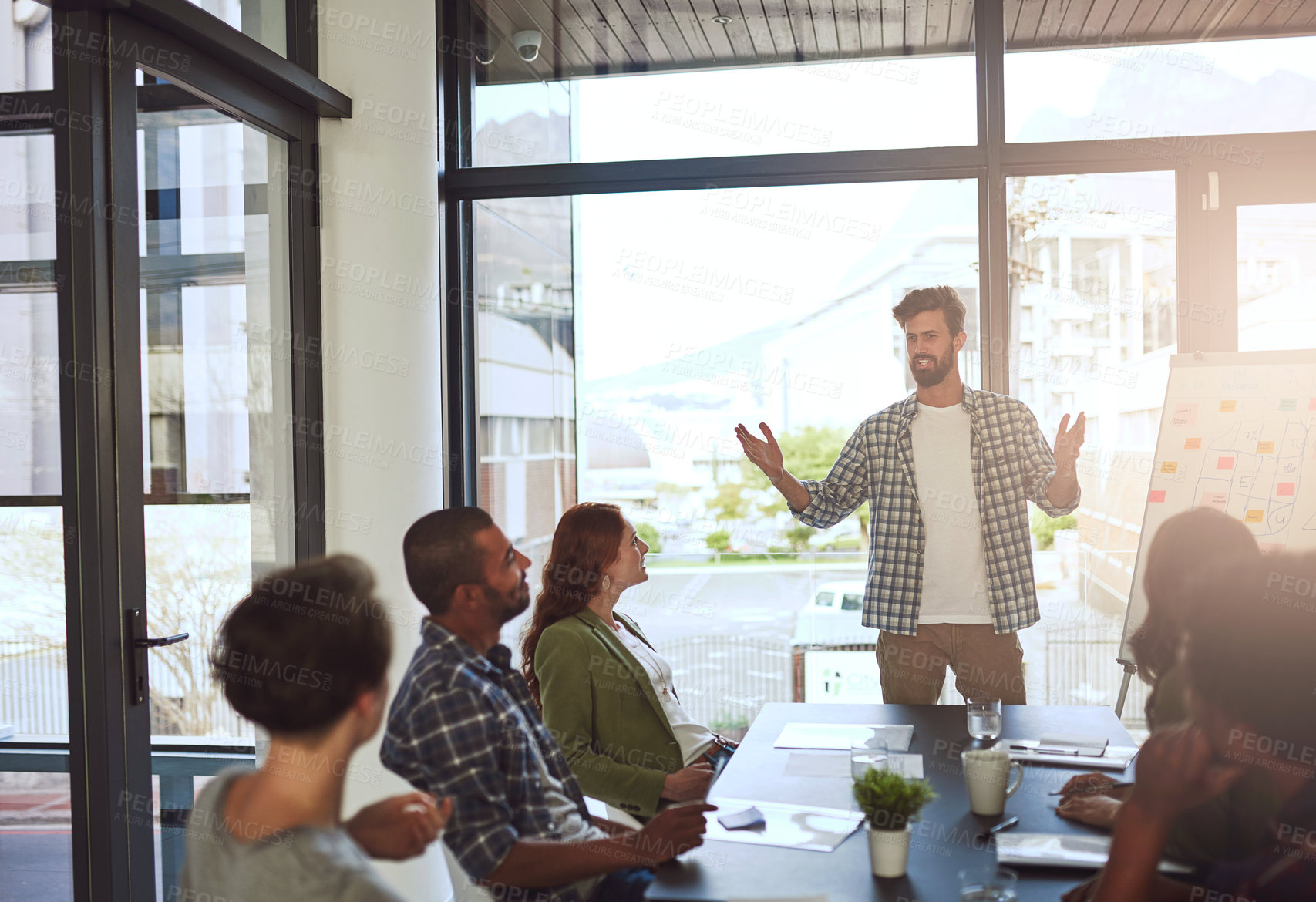 Buy stock photo Shot of a businessman giving a presentation to his coworkers in a modern office