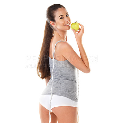 Buy stock photo Woman, body and measurement with apple in studio on white background with tape for progress, weight loss and exercise. Happy, fitness and diet or nutrition with self care for health in portrait