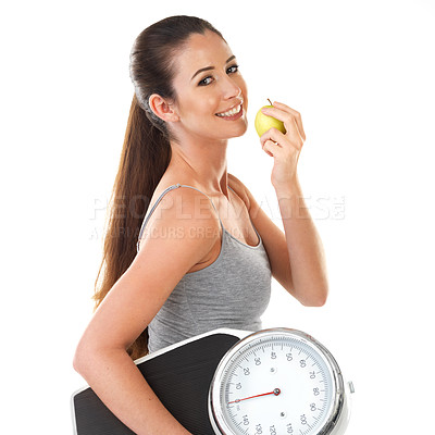 Buy stock photo Woman, scale and confident with apple in studio on white background for body weight, progress and fat loss with fitness. Portrait, happy and healthy with diet or nutrition with self care for health