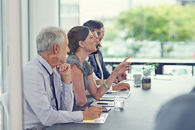 Buy stock photo Cropped shot of a group of businesspeople sitting in a meeting
