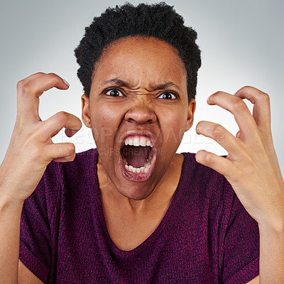 Buy stock photo Portrait of an angry young woman screaming against a grey background