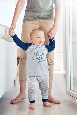 Buy stock photo Parent, boy and baby in home, walking and learning with support, growth and development of child. House, happy and cute toddler with smile, wood and floor in apartment, steps and standing with care