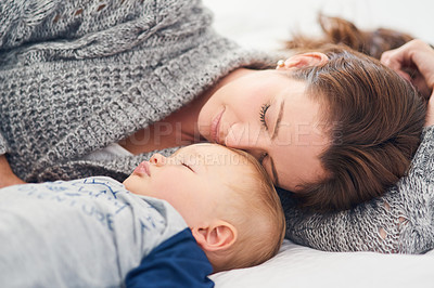 Buy stock photo Cropped shot of a mother and her baby boy sleeping together at home