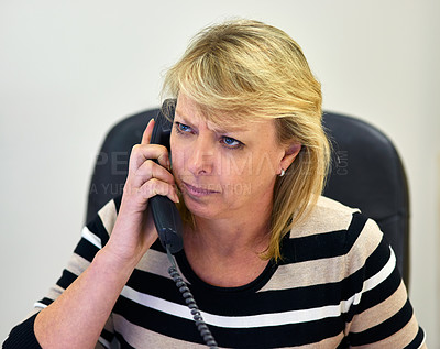 Buy stock photo Cropped shot of an angry woman talking on a phone