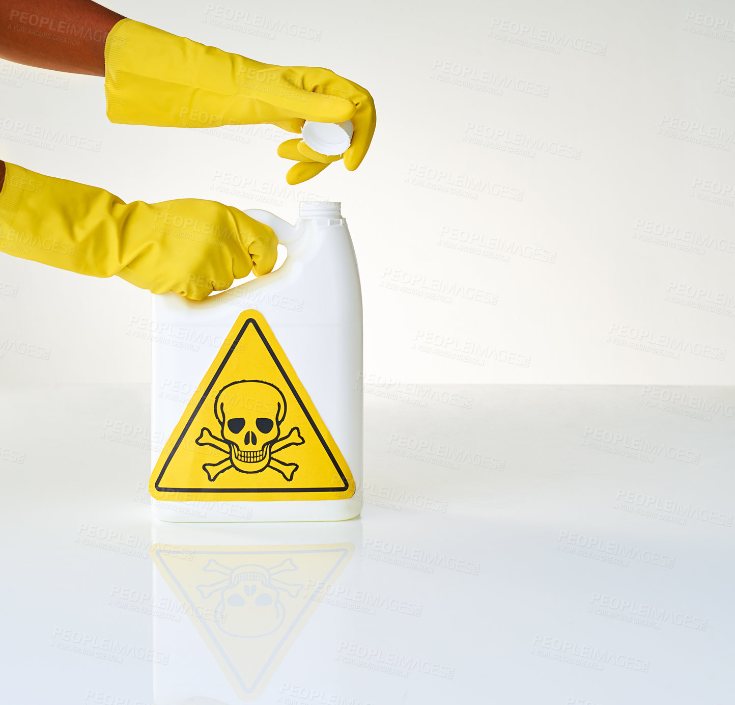 Buy stock photo Cropped shot of a person opening a bottle of toxic liquid against a grey background