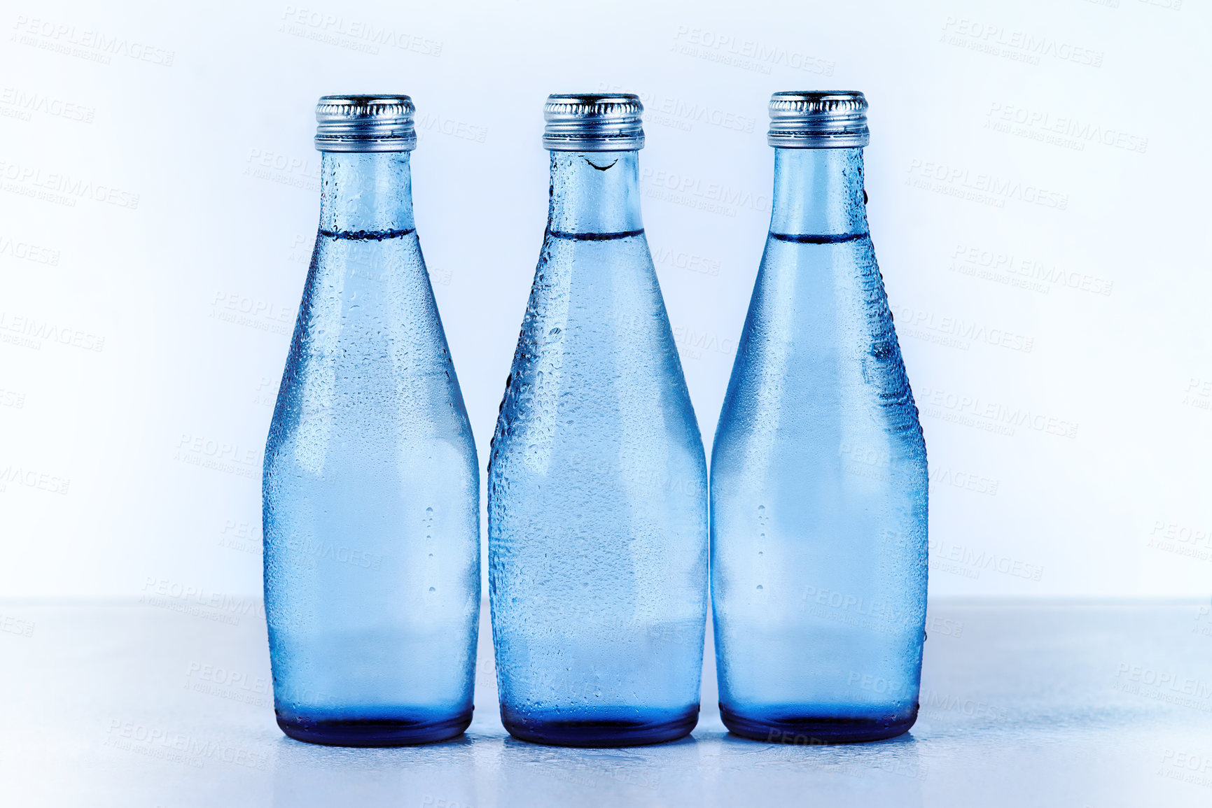 Buy stock photo Studio shot of three glass water bottles