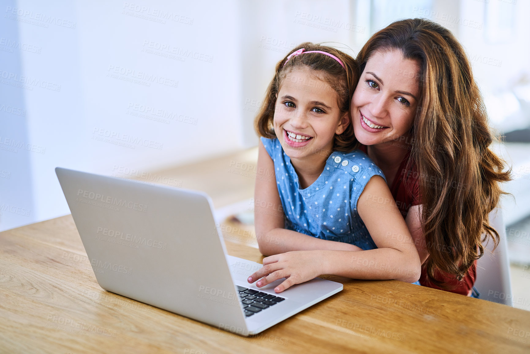 Buy stock photo Portrait of a mother and daughter using a laptop together at home