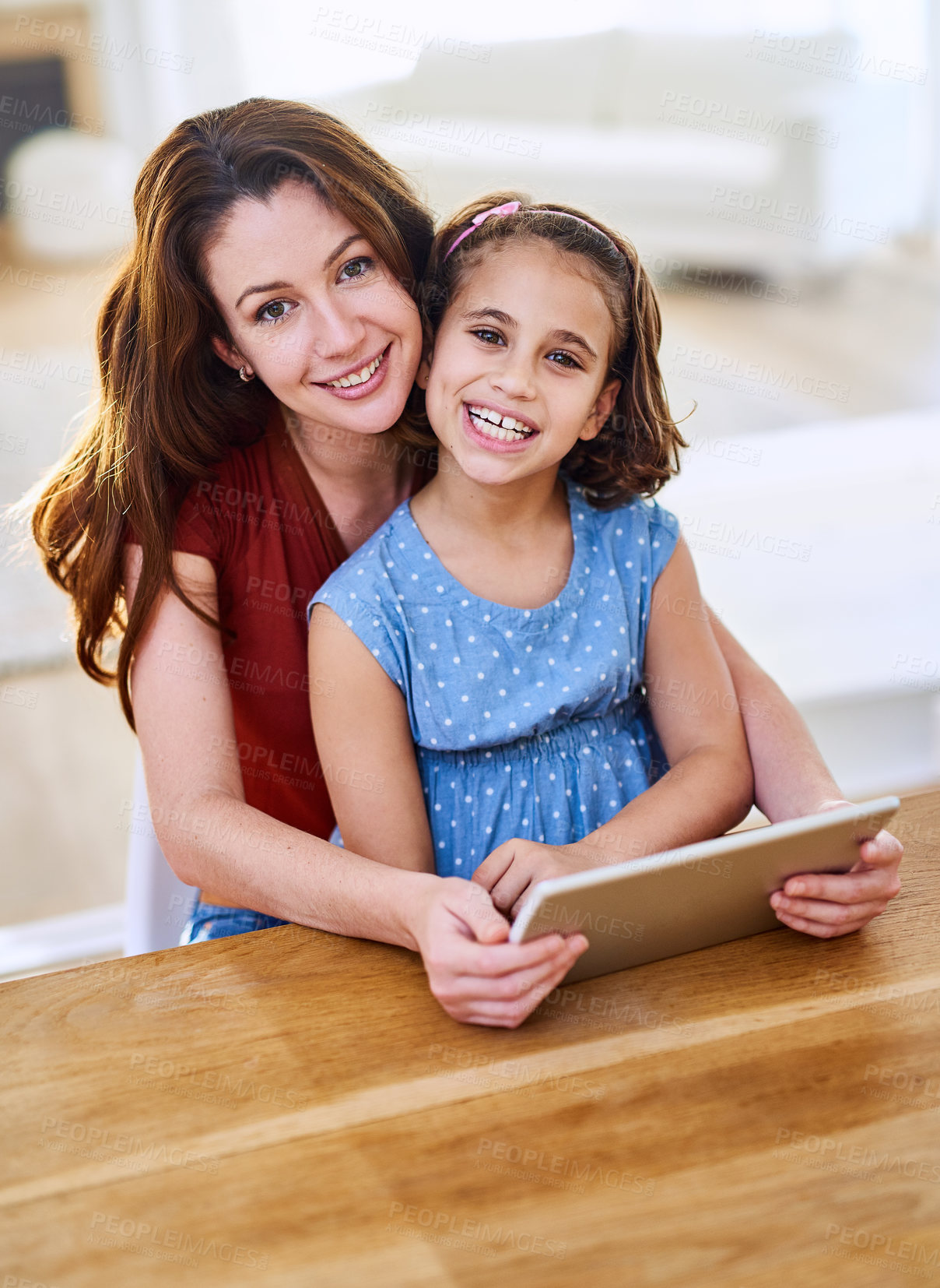 Buy stock photo Portrait of a mother and daughter using a digital tablet together at home