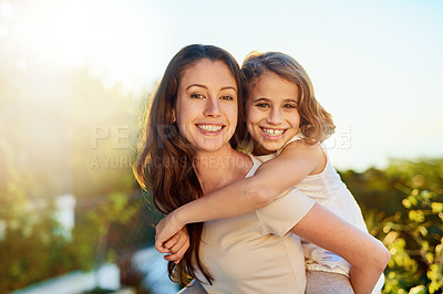 Buy stock photo Portrait of a mother giving her daughter a piggyback ride outside