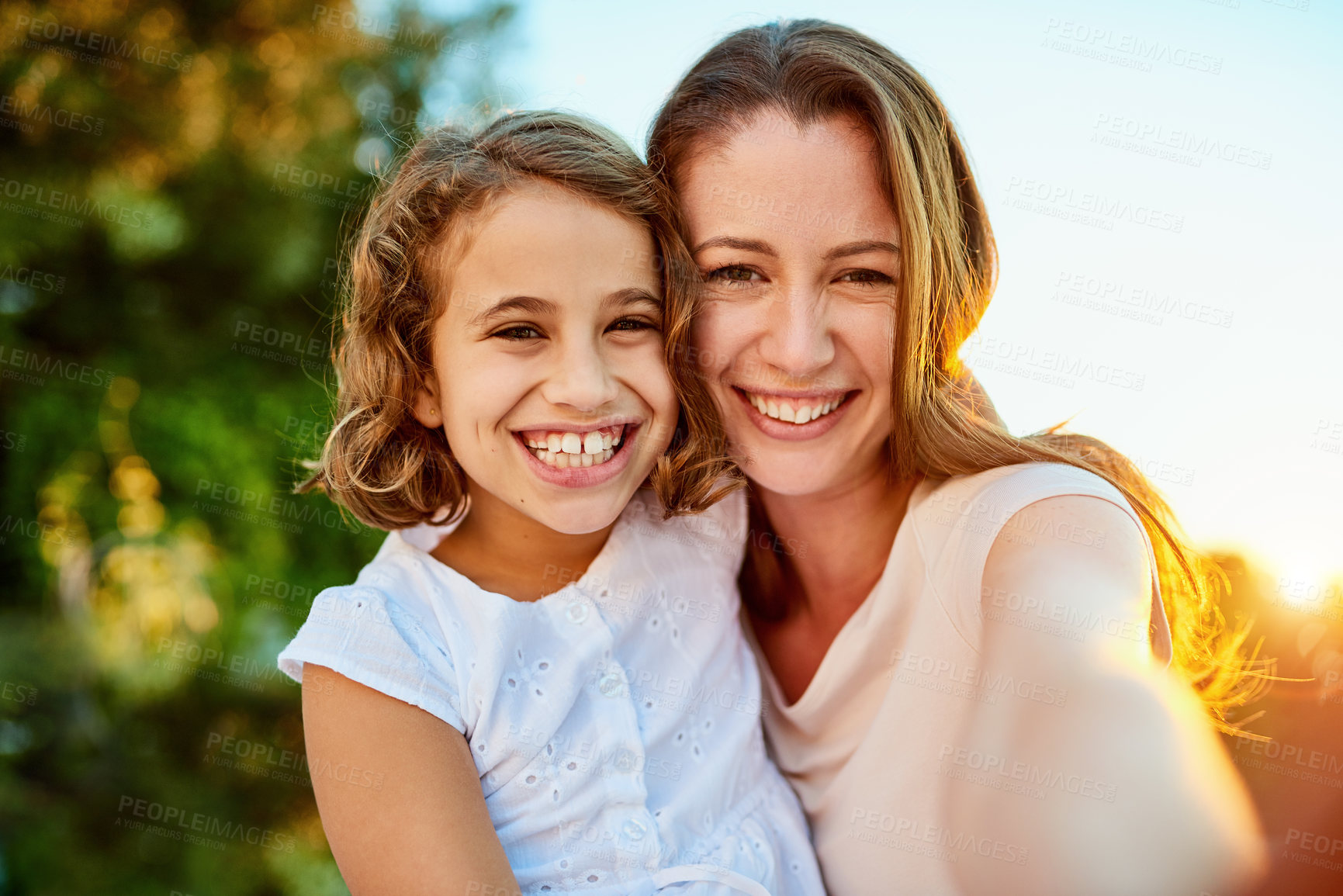 Buy stock photo Portrait of a mother and daughter taking a selfie together outside