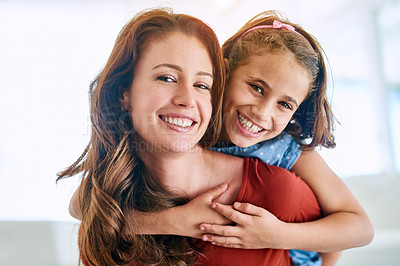 Buy stock photo Portrait of a mother giving her daughter a piggyback ride at home