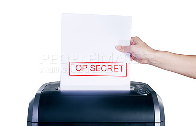 Buy stock photo Studio shot of a woman's hand placing a confidential document into a shredder against a white background