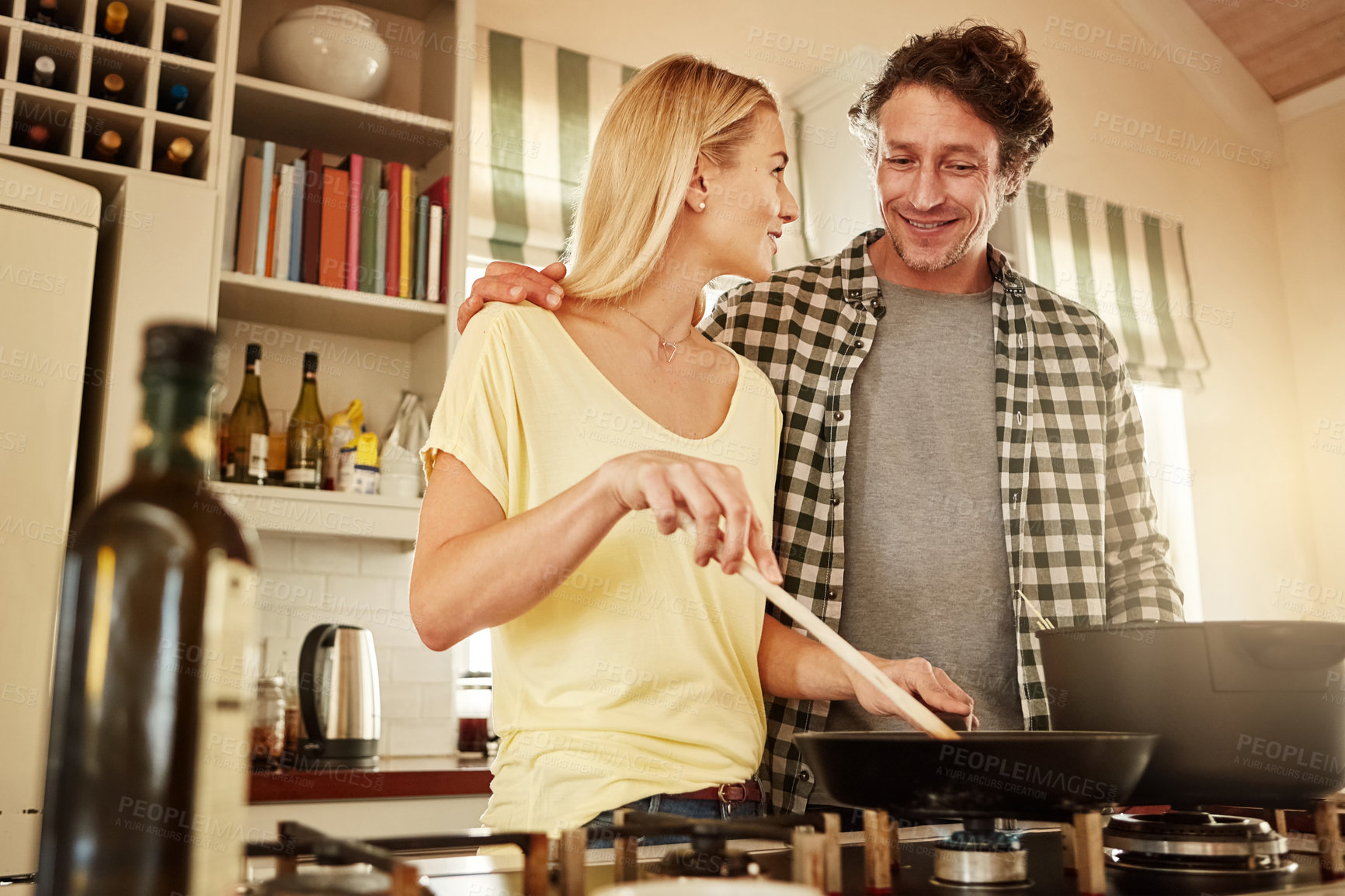Buy stock photo Speaking, support or happy couple kitchen cooking with healthy food for lunch together at home. Affection, love or woman helping, smiling or talking to husband in meal preparation in Australia