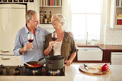 Buy stock photo Love, wine or happy old couple cooking food for a healthy diet together with love in retirement at home. Hugging or happy senior woman laughing or drinking in kitchen with mature husband at dinner