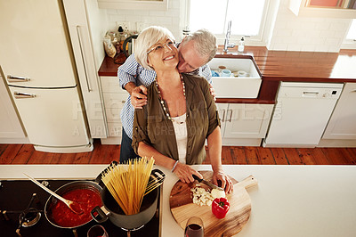 Buy stock photo Kiss, hug or old couple cooking food for a healthy vegan diet together with love in retirement at home. Smile, romance or elderly husband kissing or hugging senior woman in house kitchen at dinner