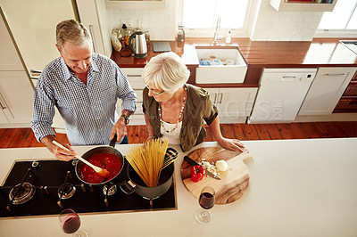 Buy stock photo Help, support or old couple cooking food for a healthy vegan diet together with love in retirement at home. Spaghetti or top few of senior woman bonding in house kitchen with mature husband at dinner