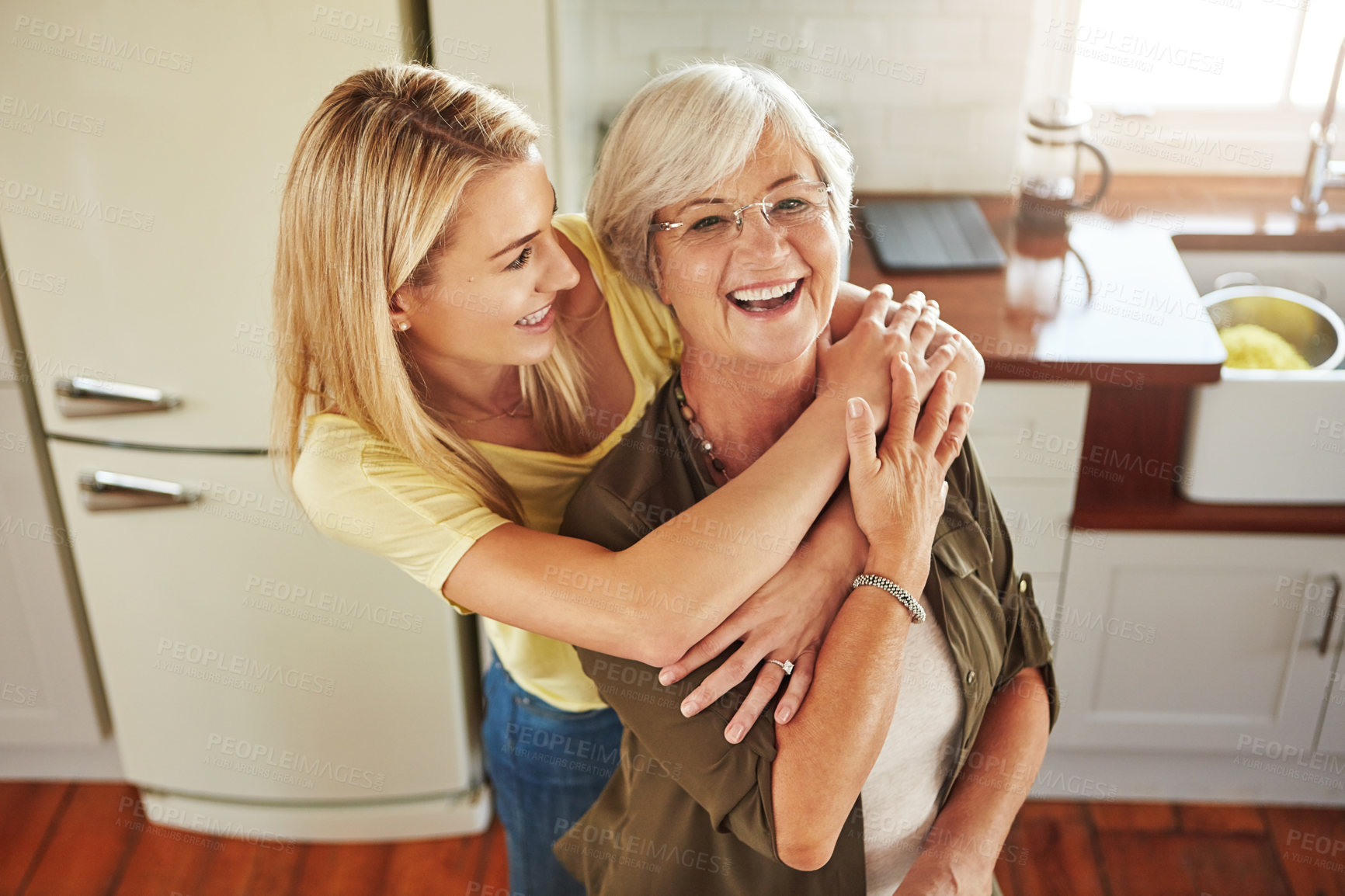 Buy stock photo Hug, woman or portrait of mother laughing in kitchen in bonding together with love at home in Italy. Happy family, embrace or adult child hugging a funny senior mom in house cooking lunch or dinner