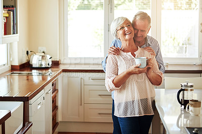 Buy stock photo Hugging, coffee or old couple laughing in kitchen at home bonding or enjoying quality time together. Embrace, retirement or happy mature man talking, relaxing or drinking tea with funny senior woman