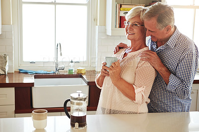 Buy stock photo Chat, coffee or old couple hugging in kitchen at home bonding or enjoying quality morning time together. Embrace, happy retirement or senior man talking, relaxing or drinking tea with a mature woman 