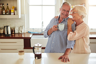 Buy stock photo Hug, coffee or happy old couple in kitchen at home bonding or enjoying quality morning time together. Embrace, retirement or senior man talking, relaxing or drinking tea with a funny elderly woman