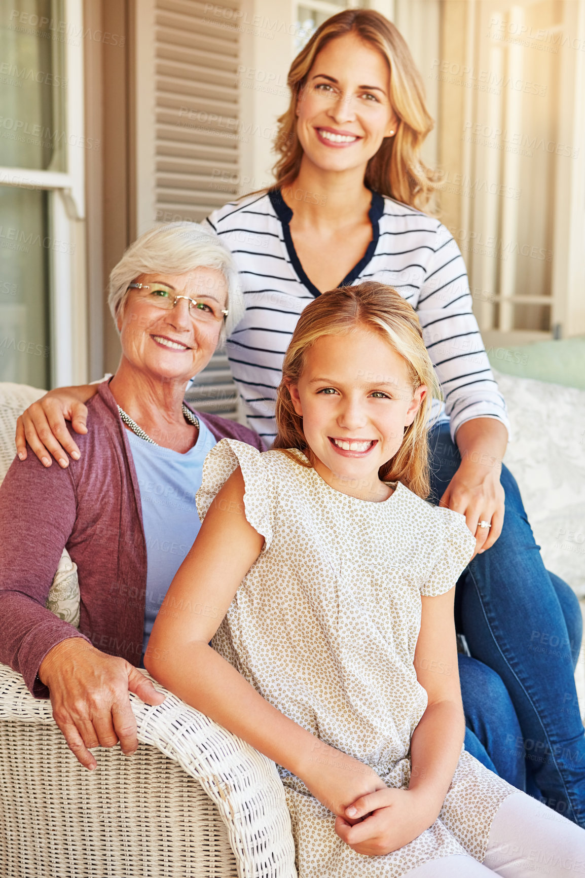 Buy stock photo Cropped portrait of a young girl sitting outside with her mother and grandmother