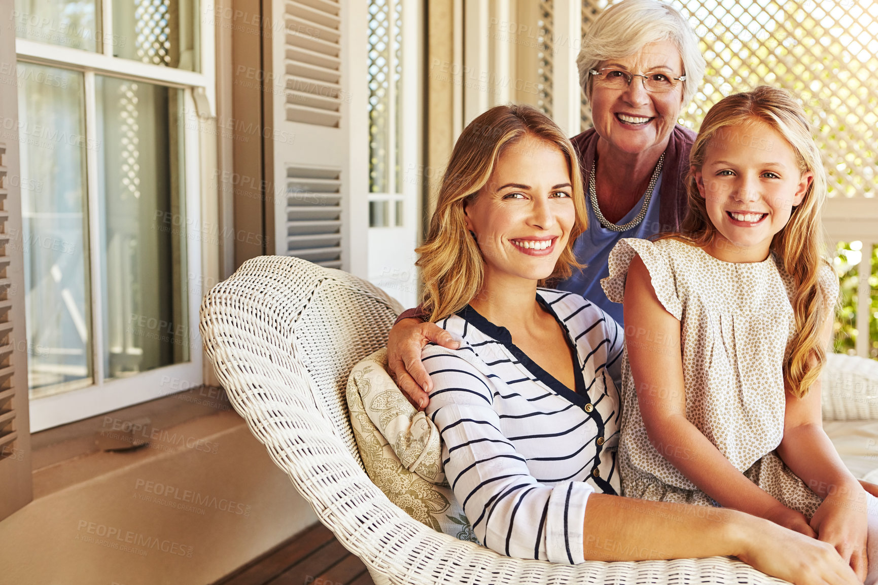 Buy stock photo Cropped portrait of a young girl sitting outside with her mother and grandmother