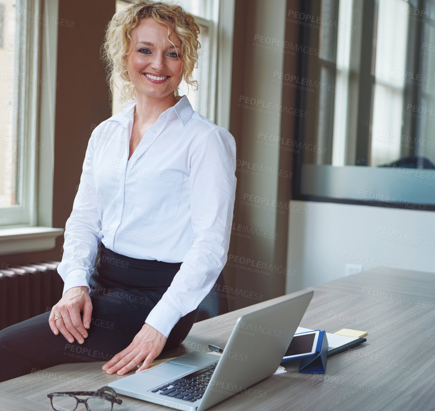 Buy stock photo Portrait of a businesswoman working at her desk in an office