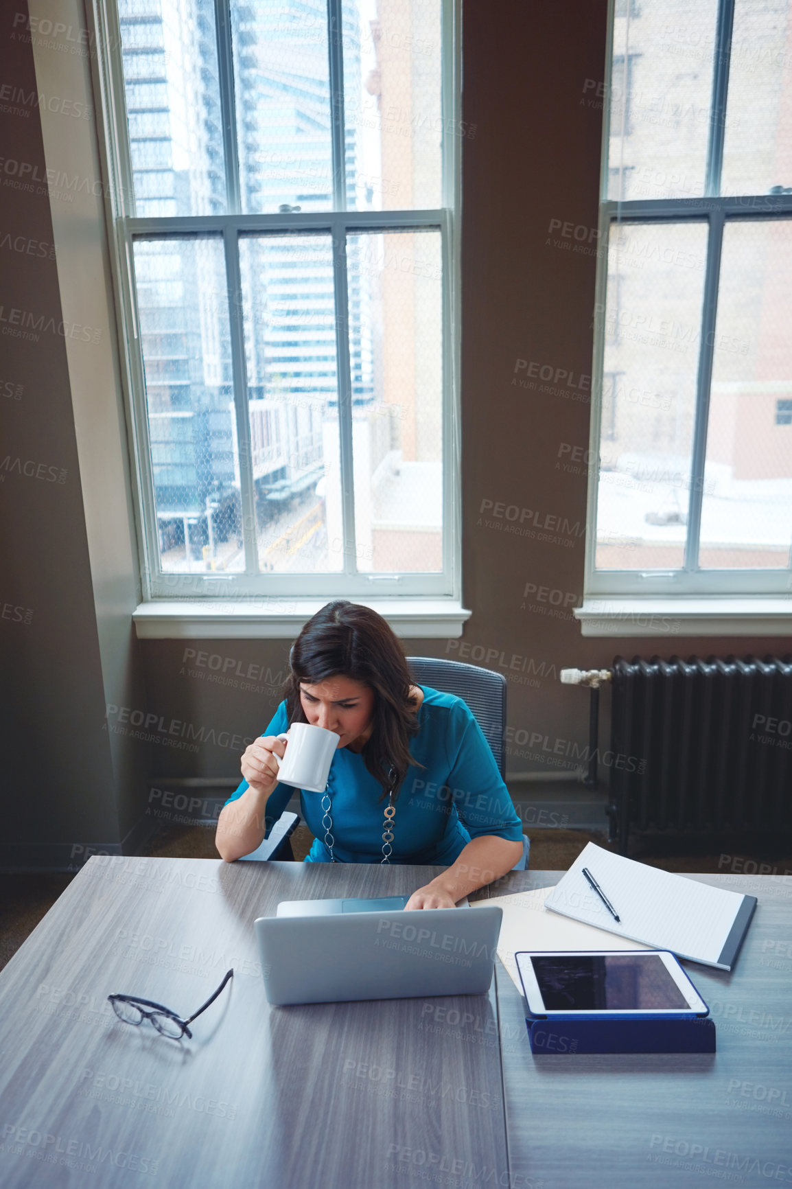 Buy stock photo Shot of a businesswoman using a laptop during a break in an office