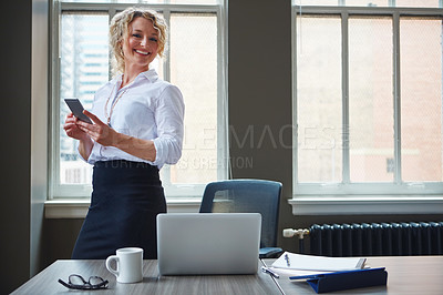 Buy stock photo Shot of a businesswoman using a phone in an office