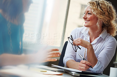 Buy stock photo Shot of two businesswomen having a meeting together in an office