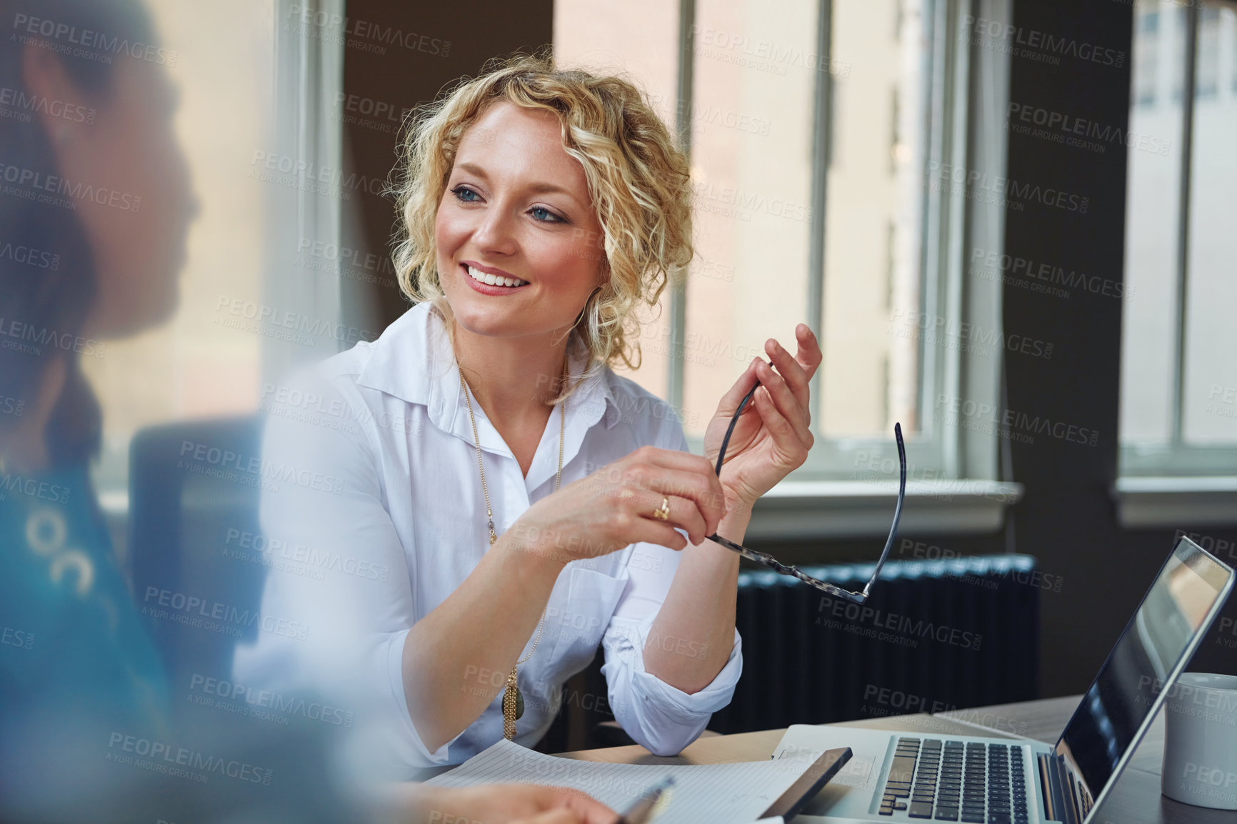 Buy stock photo Shot of two businesswomen having a meeting together in an office