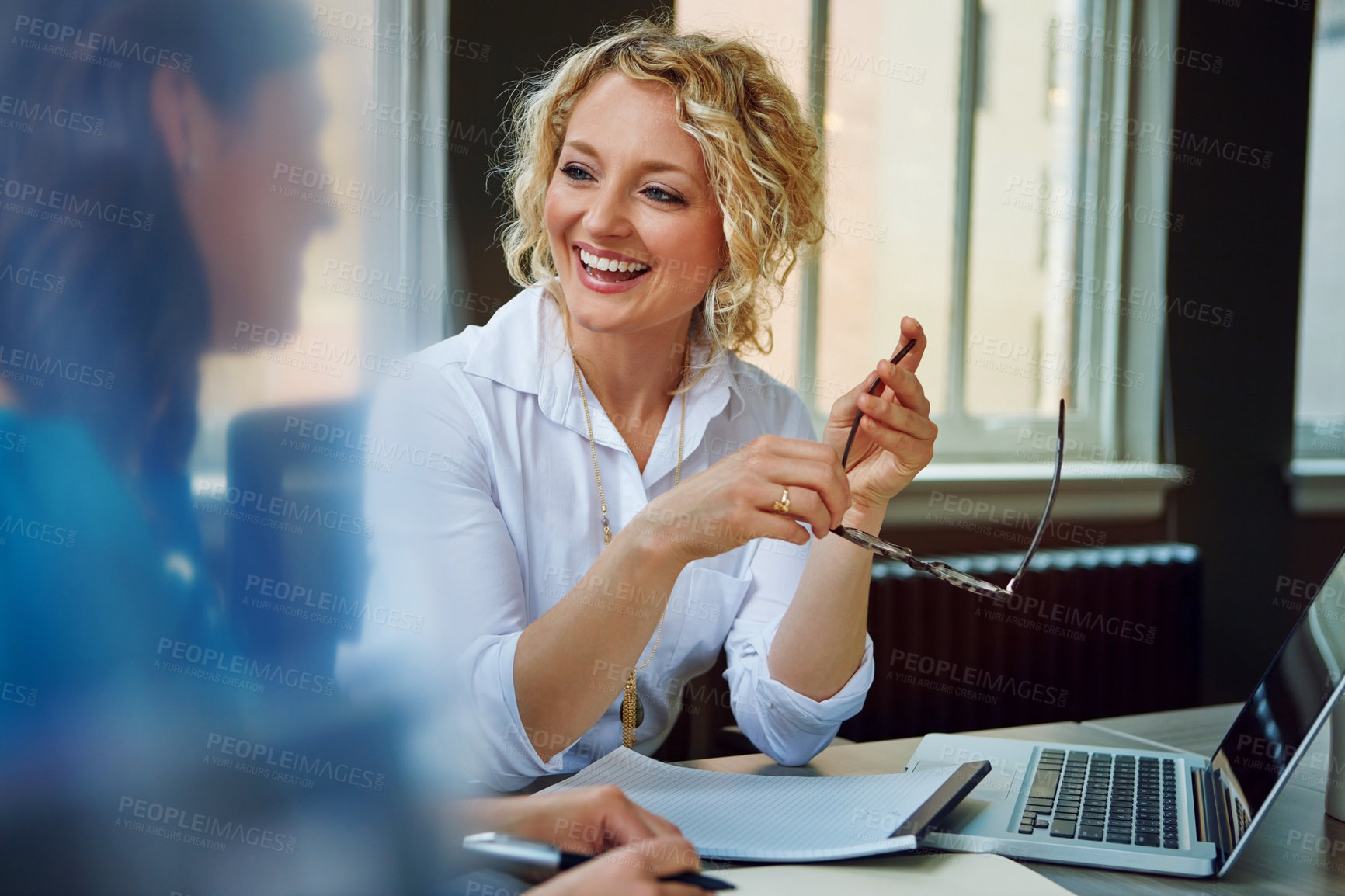 Buy stock photo Shot of two businesswomen having a meeting together in an office