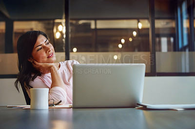 Buy stock photo Shot of a businesswoman daydreaming while working on a laptop in an office
